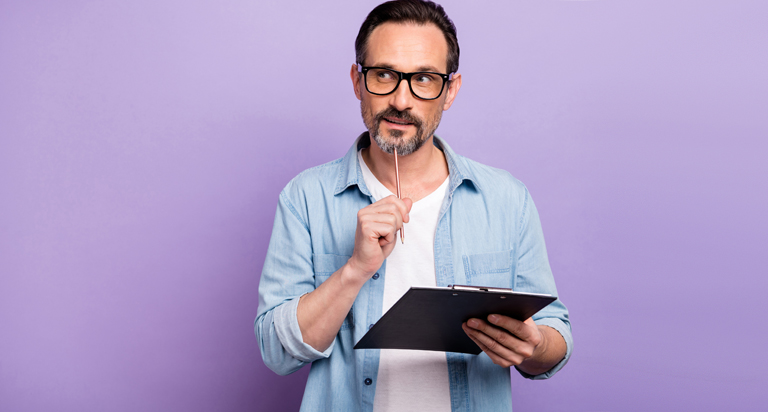 Man looking at clipboard